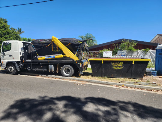 Truck delivering and collecting skip